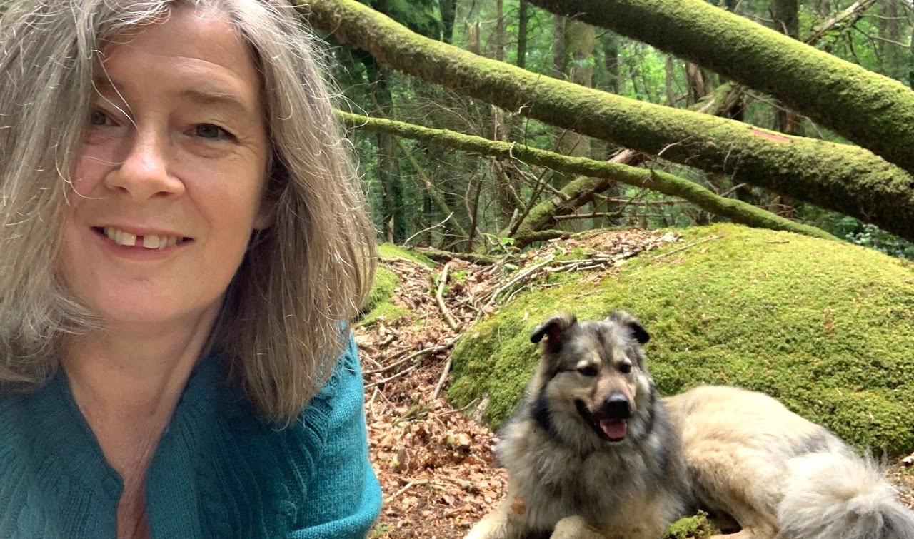 woman and dog in the woods